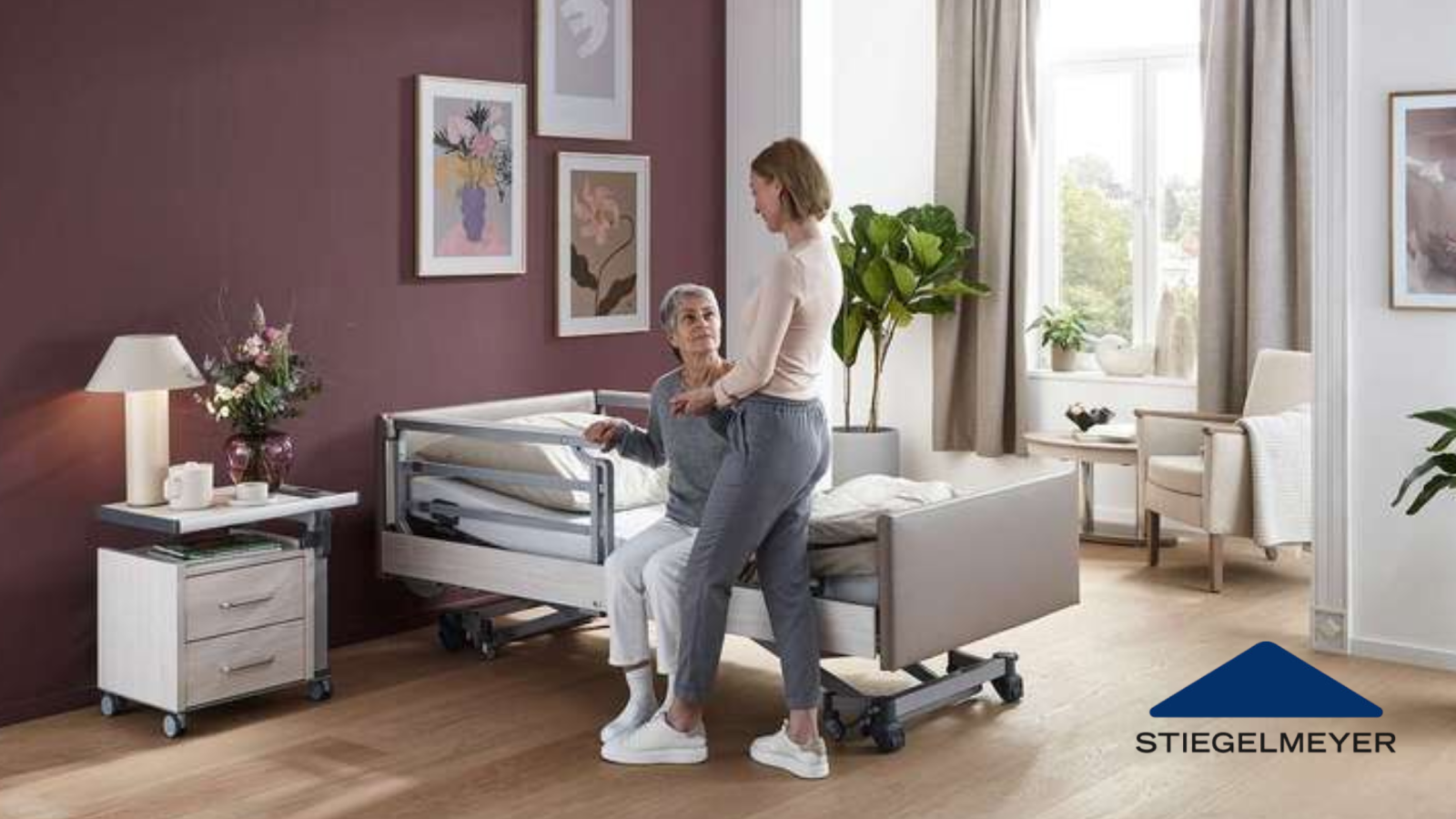 carer helping with safe transfers near an adjustable homecare bed