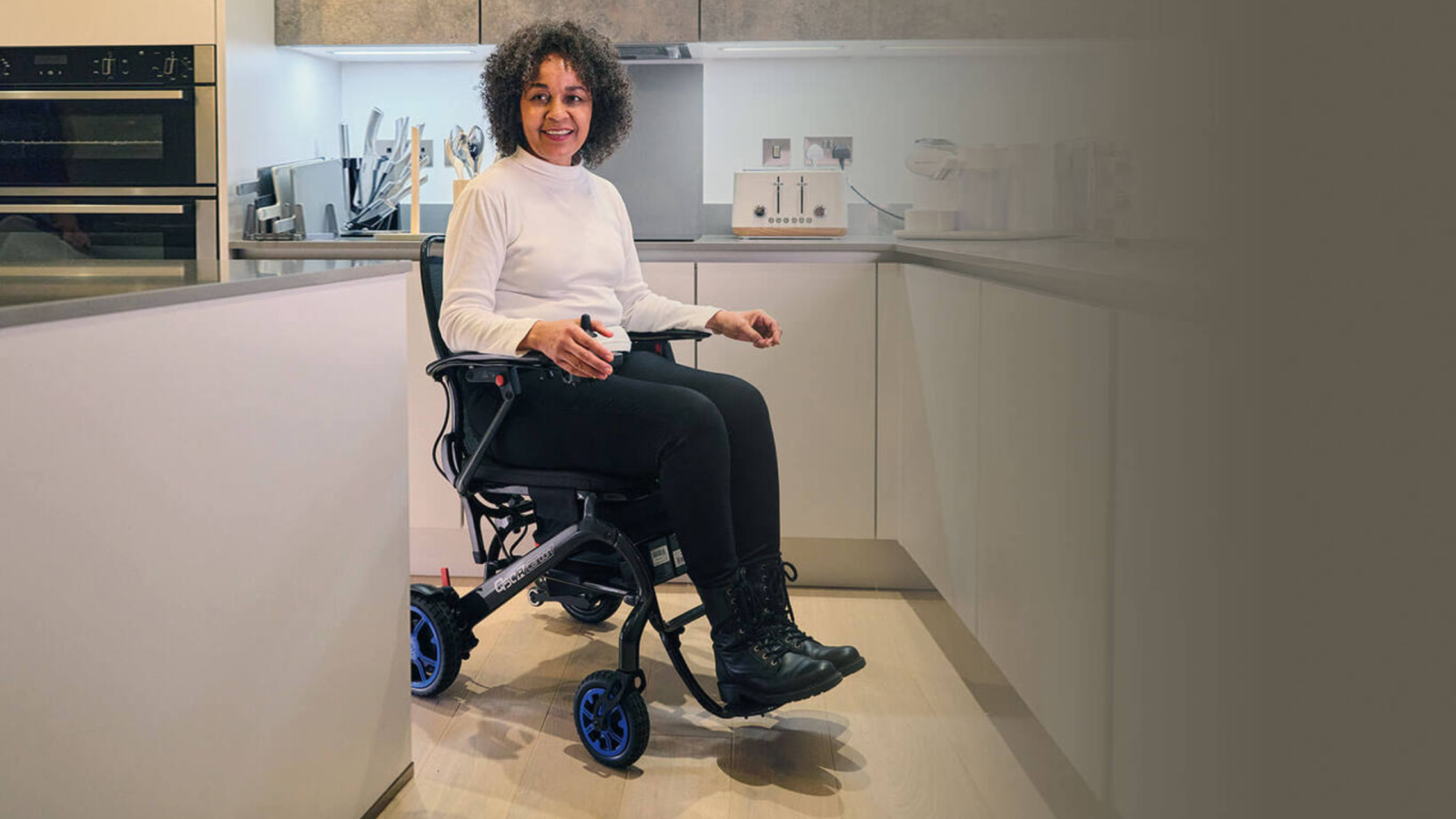 Lightweight folding wheelchair being used indoors in a bedroom